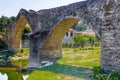 three archs medieval humpback bridge in Italy